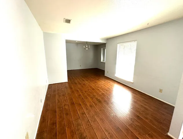 a view of a room with wooden floor