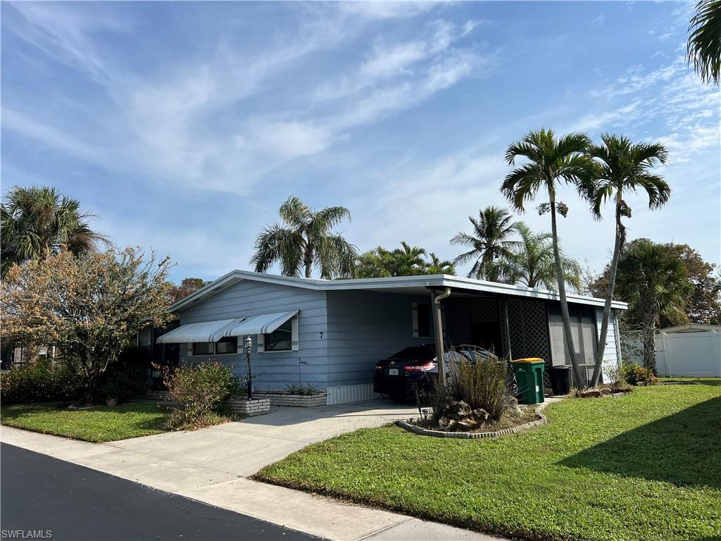 7 Oceans Boulevard, Unit 7 Naples, FL 34104 - Photo 1 of 32 View of front of property with a front yard and a carport