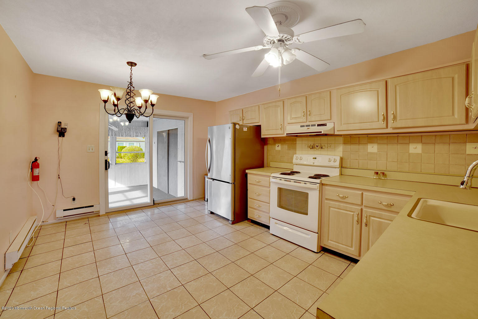 136 Rigi Strasse, Unit 1000 Freehold, NJ 07728 - Photo 4 of 25 a kitchen with stainless steel appliances granite countertop a stove a sink and a refrigerator