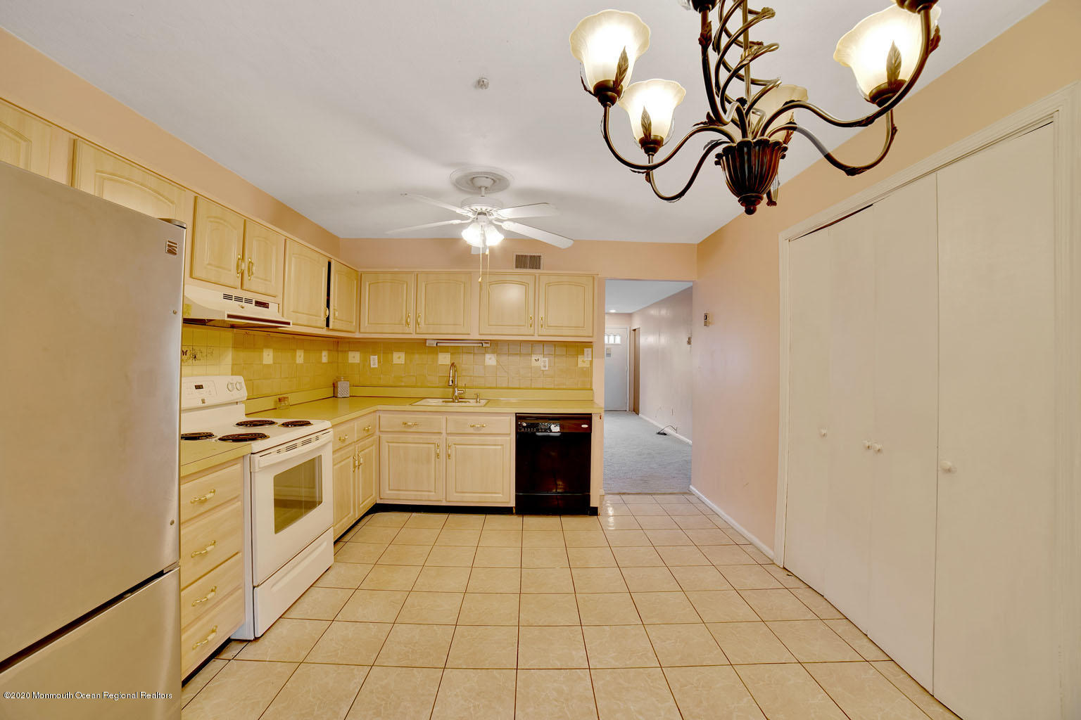 136 Rigi Strasse, Unit 1000 Freehold, NJ 07728 - Photo 5 of 25 a kitchen with stainless steel appliances granite countertop a sink a stove top oven and cabinets