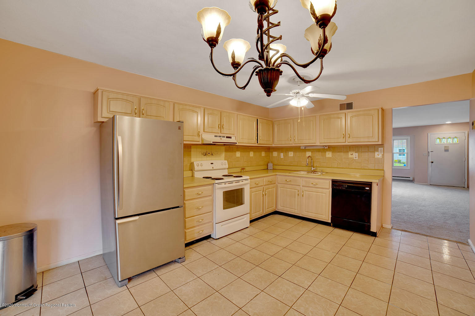 136 Rigi Strasse, Unit 1000 Freehold, NJ 07728 - Photo 6 of 25 a white kitchen with a refrigerator a stove top oven a sink and dishwasher