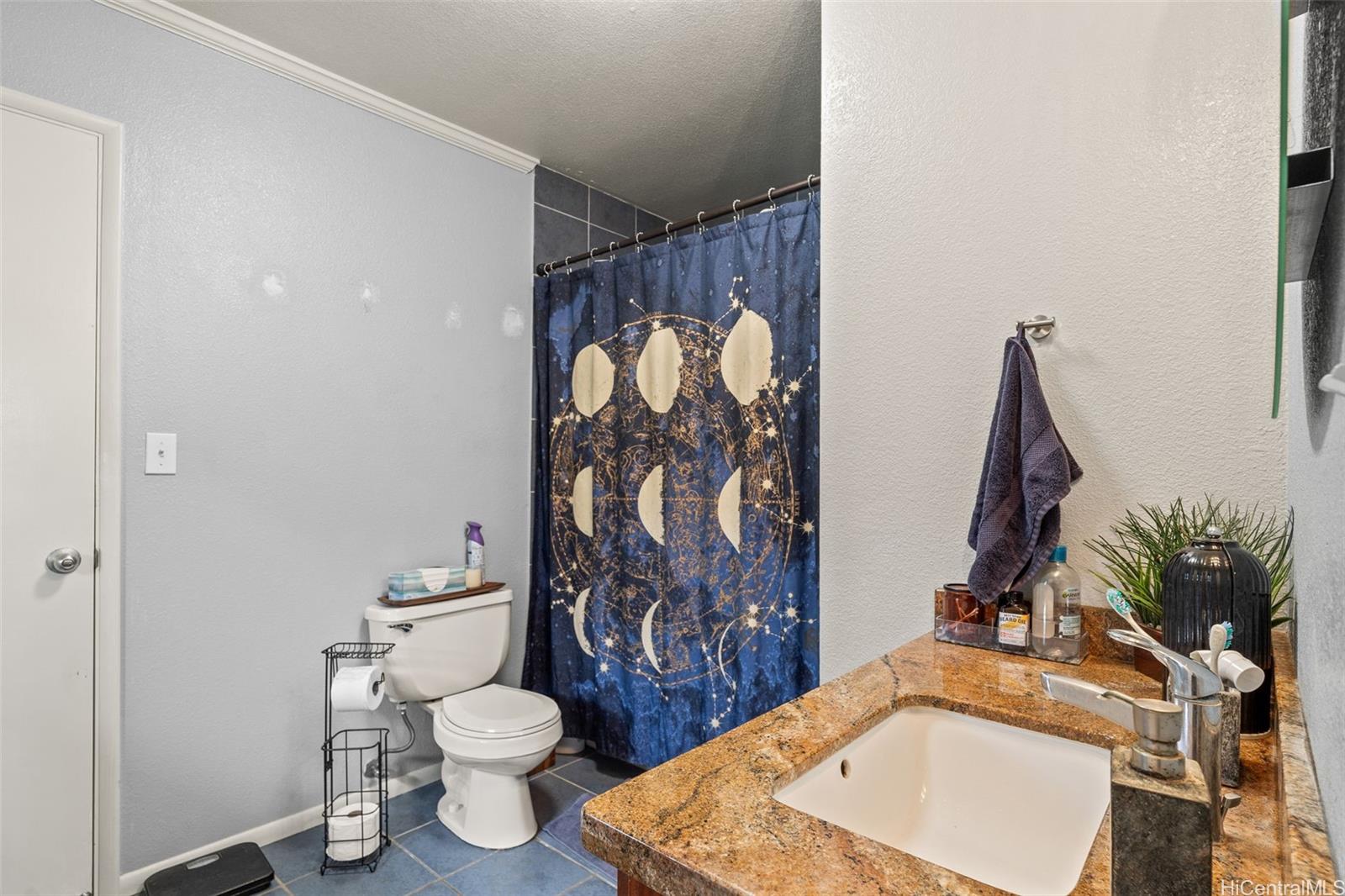 51-17 Kaʻaʻawa Place Kaaawa, HI 96730 - Photo 14 of 25 a bathroom with a toilet sink and mirror