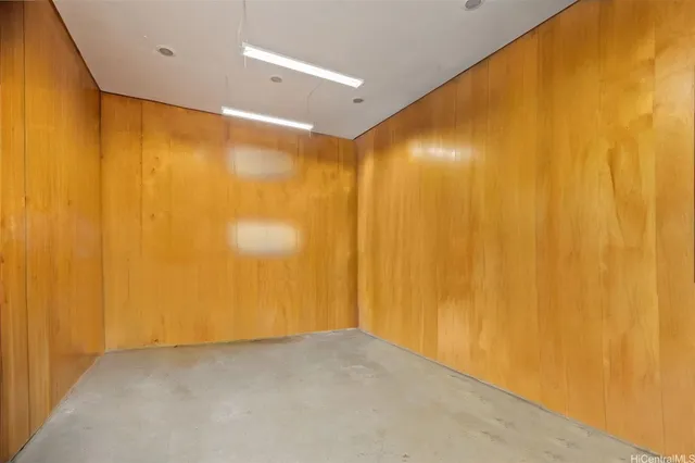 a view of empty room with wooden walls