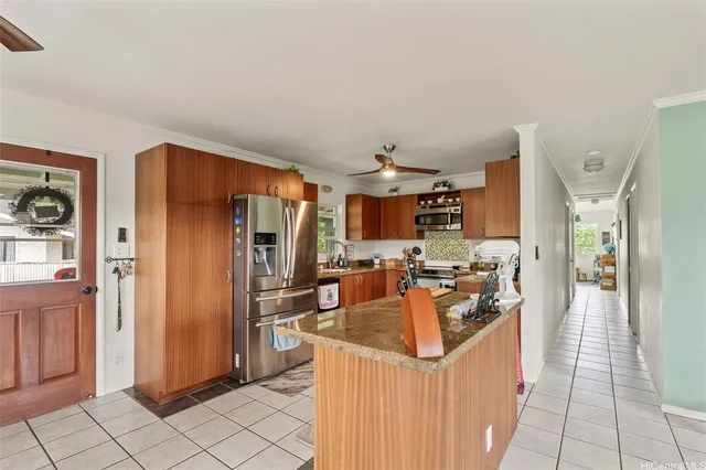 a kitchen with stainless steel appliances granite countertop a refrigerator and a sink