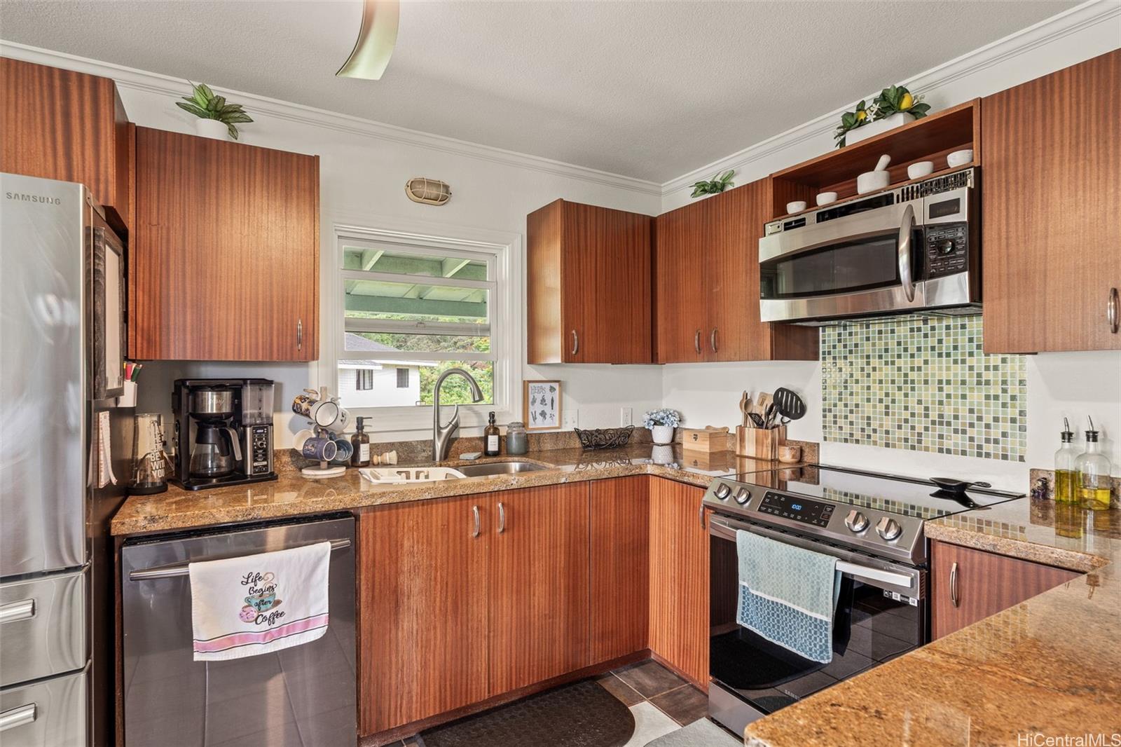 51-17 Kaʻaʻawa Place Kaaawa, HI 96730 - Photo 6 of 25 a kitchen with stainless steel appliances granite countertop a sink stove and refrigerator