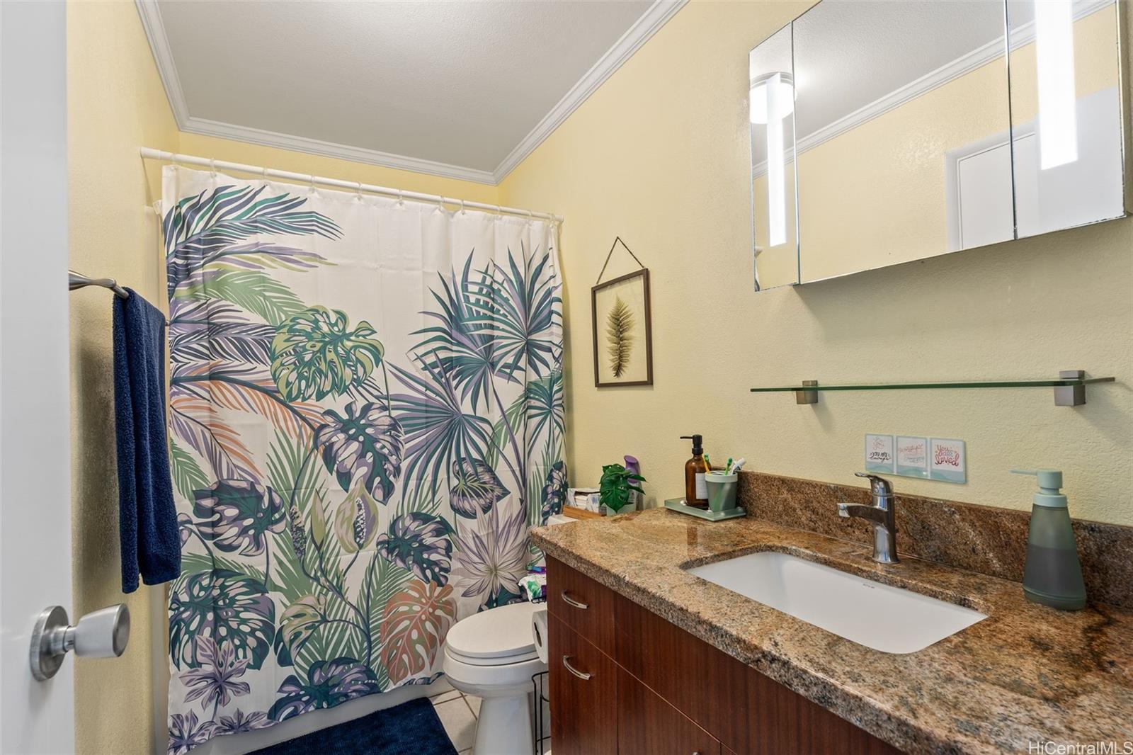 51-17 Kaʻaʻawa Place Kaaawa, HI 96730 - Photo 8 of 25 a bathroom with a granite countertop sink a toilet and a mirror