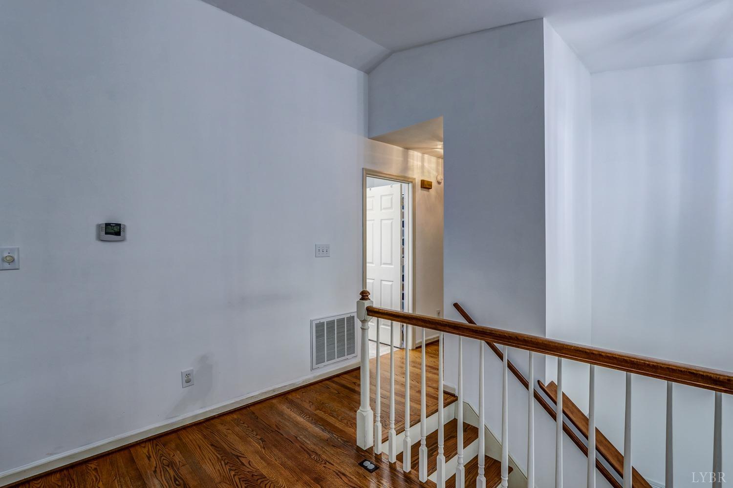 127 Southern Lane Monroe, VA 24574 - Photo 13 of 44 a view of a hallway with wooden floor and staircase