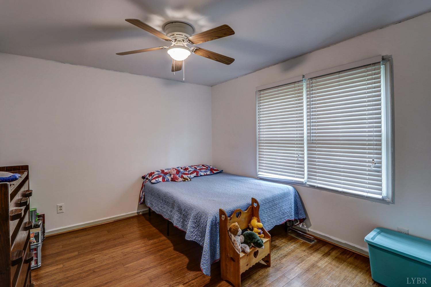 127 Southern Lane Monroe, VA 24574 - Photo 18 of 44 a bedroom with a bed and a chandelier