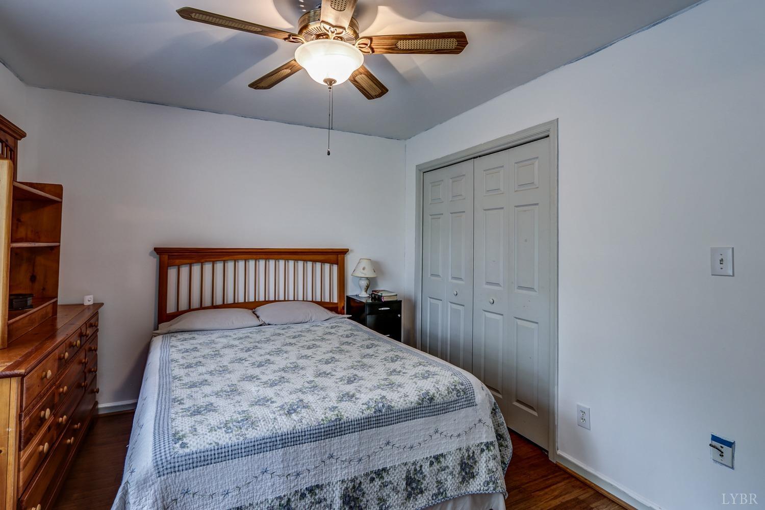 127 Southern Lane Monroe, VA 24574 - Photo 21 of 44 a bedroom with a bed and a chandelier
