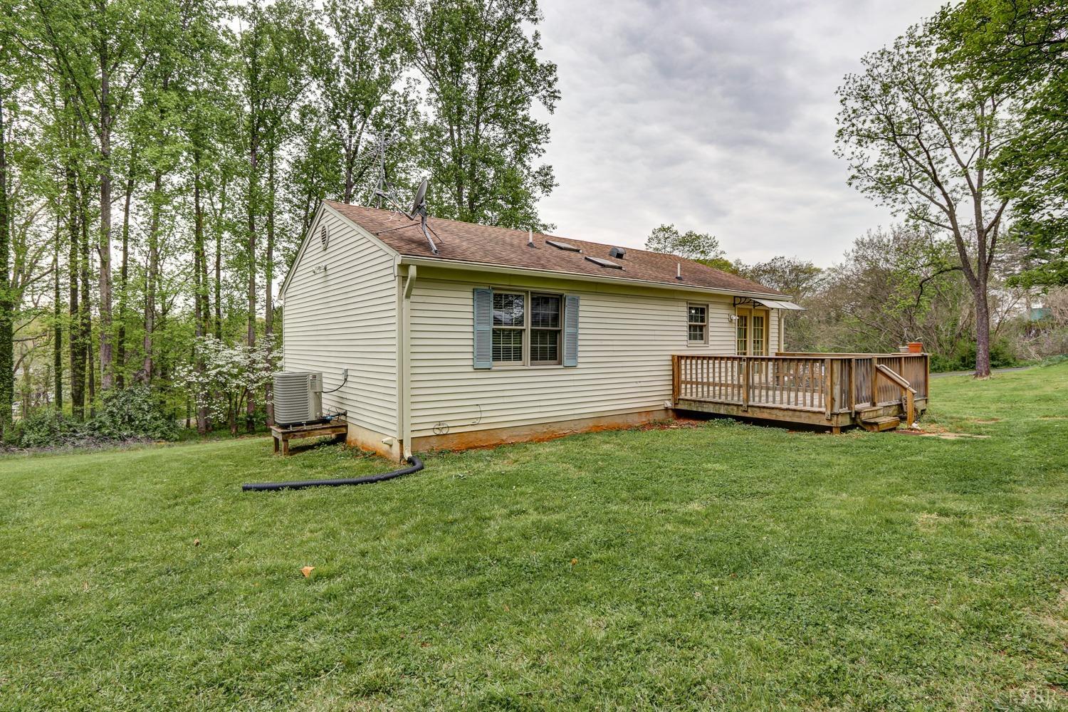 127 Southern Lane Monroe, VA 24574 - Photo 32 of 44 a backyard of a house with barbeque oven and trees
