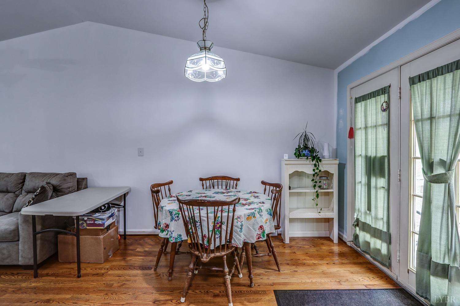 127 Southern Lane Monroe, VA 24574 - Photo 6 of 44 a view of a dining room with furniture wooden floor and a chandelier