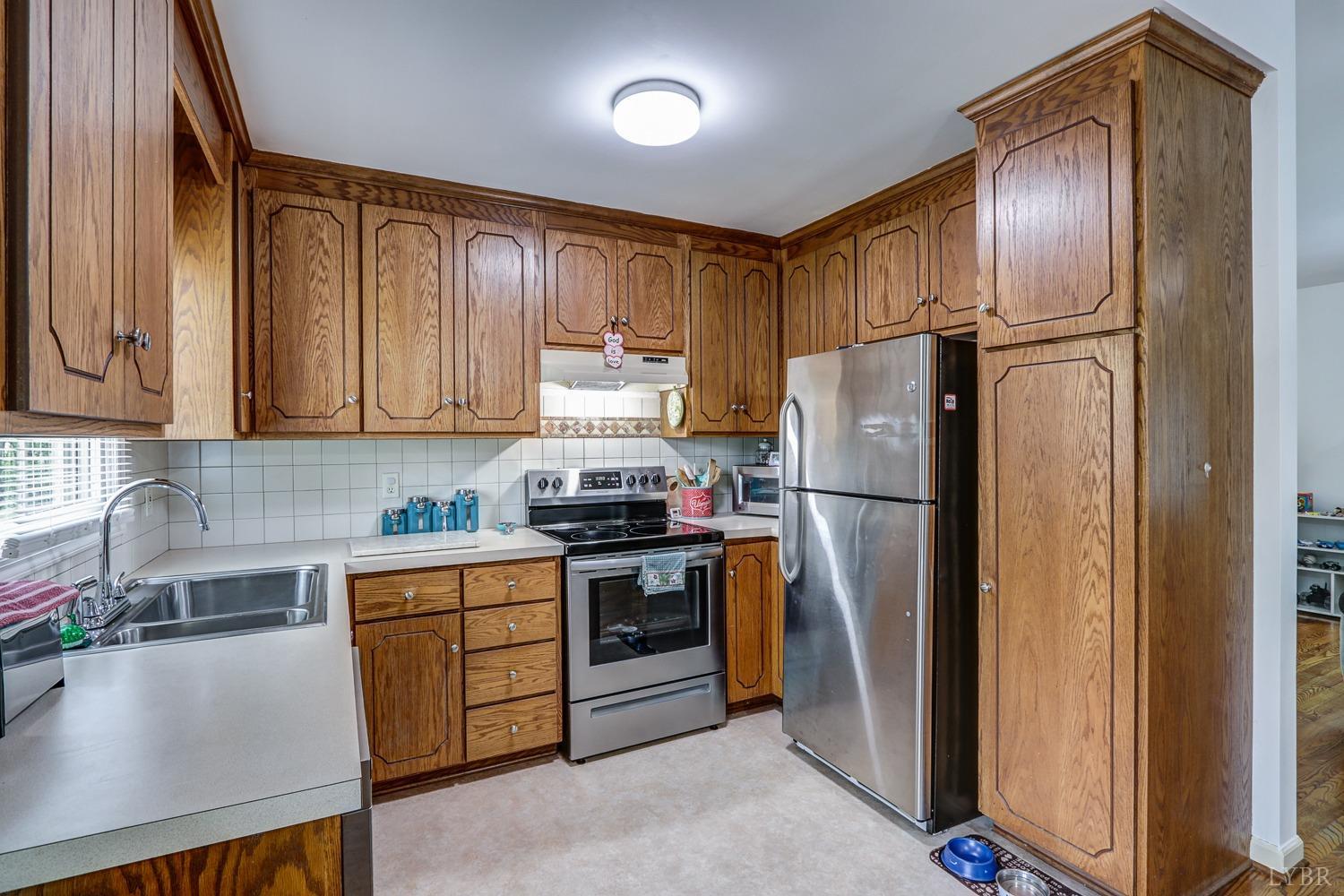 127 Southern Lane Monroe, VA 24574 - Photo 8 of 44 a kitchen with stainless steel appliances granite countertop a refrigerator sink and cabinets