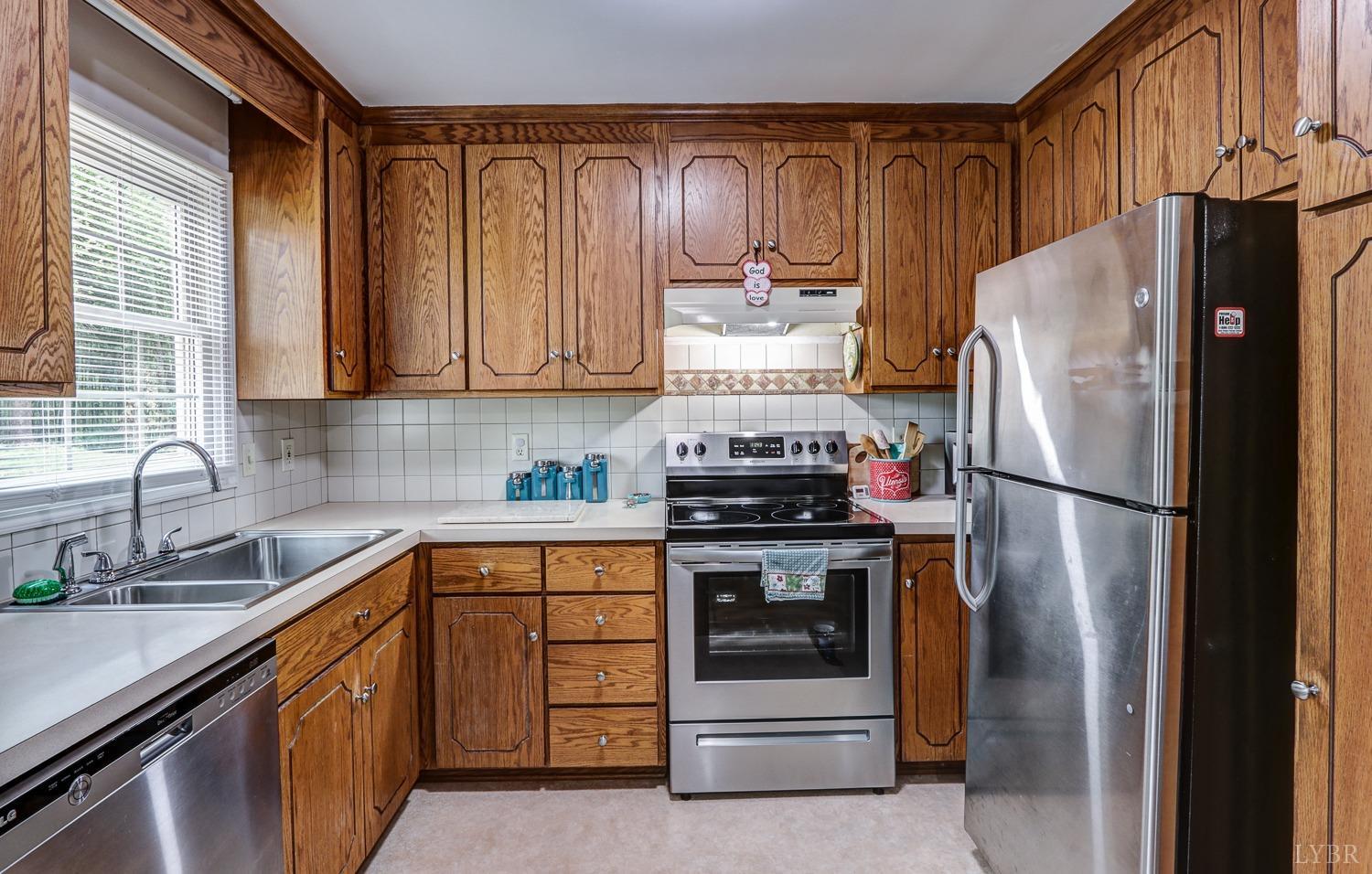 127 Southern Lane Monroe, VA 24574 - Photo 9 of 44 a kitchen with a refrigerator sink and cabinets