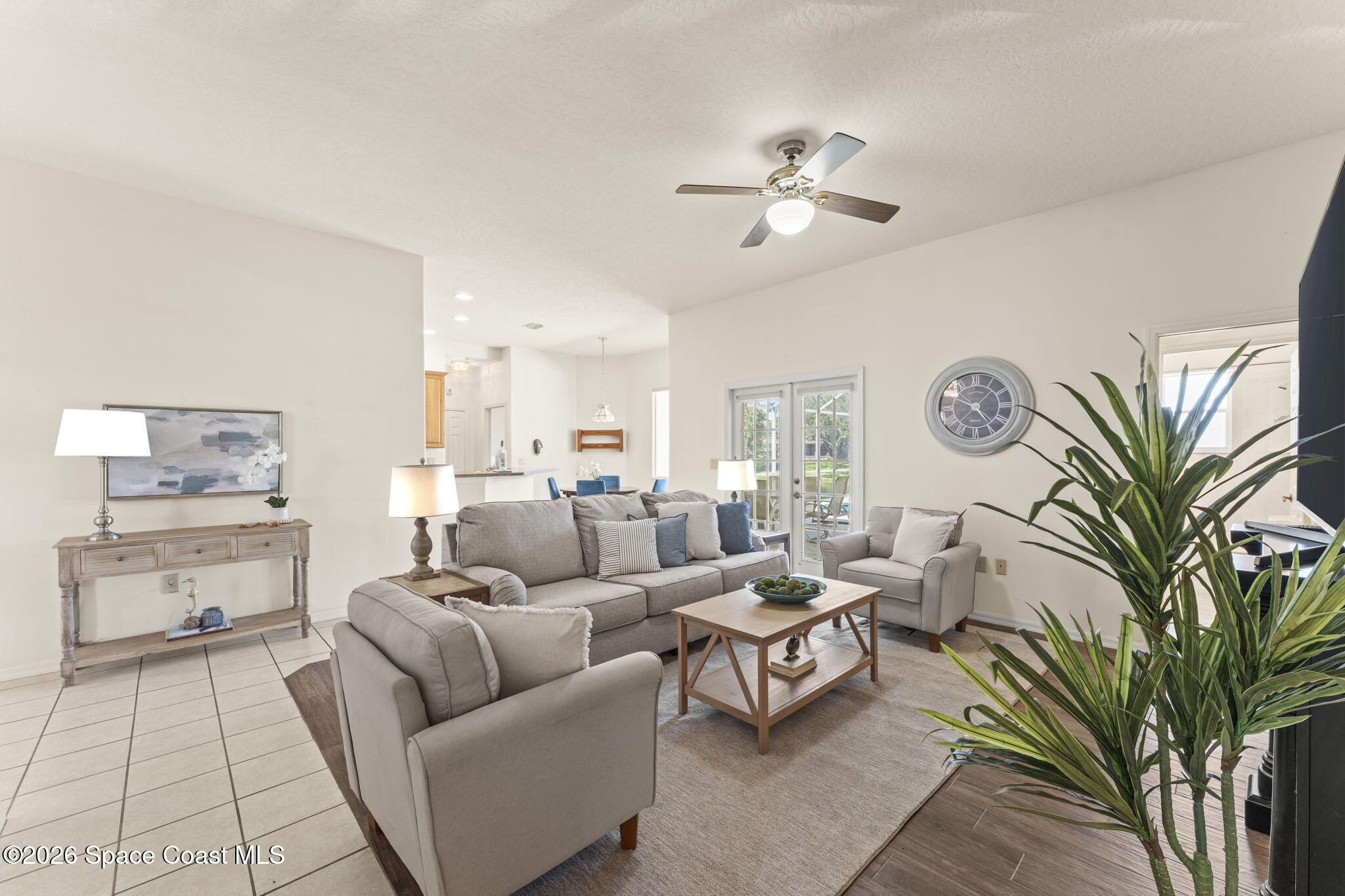 1123 Spring Oak Drive Melbourne, FL 32901 - Photo 28 of 67 a living room with furniture and a chandelier