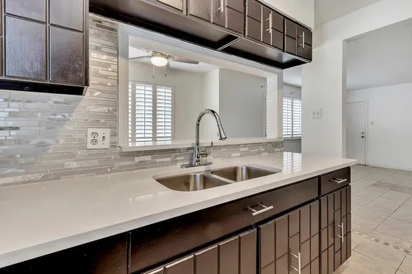 a kitchen with granite countertop a sink and a wooden cabinets