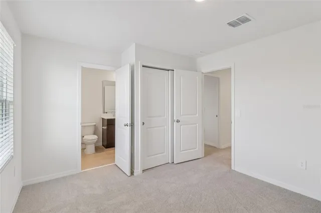 a view of an empty room and a bathroom