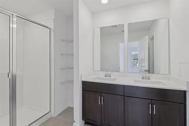 a bathroom with a double vanity sink mirror and double
