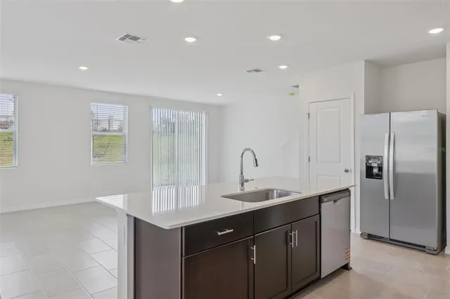 a kitchen with a sink appliances and cabinets