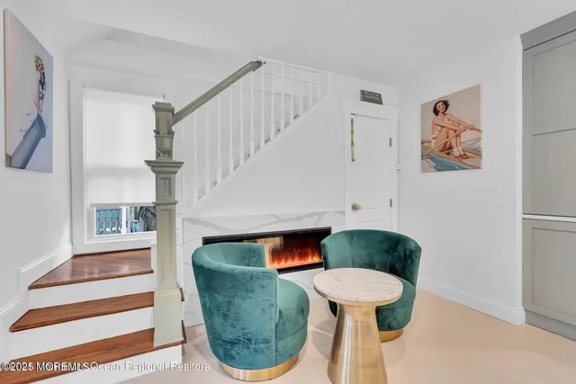 a living room with furniture a flat screen tv and kitchen view