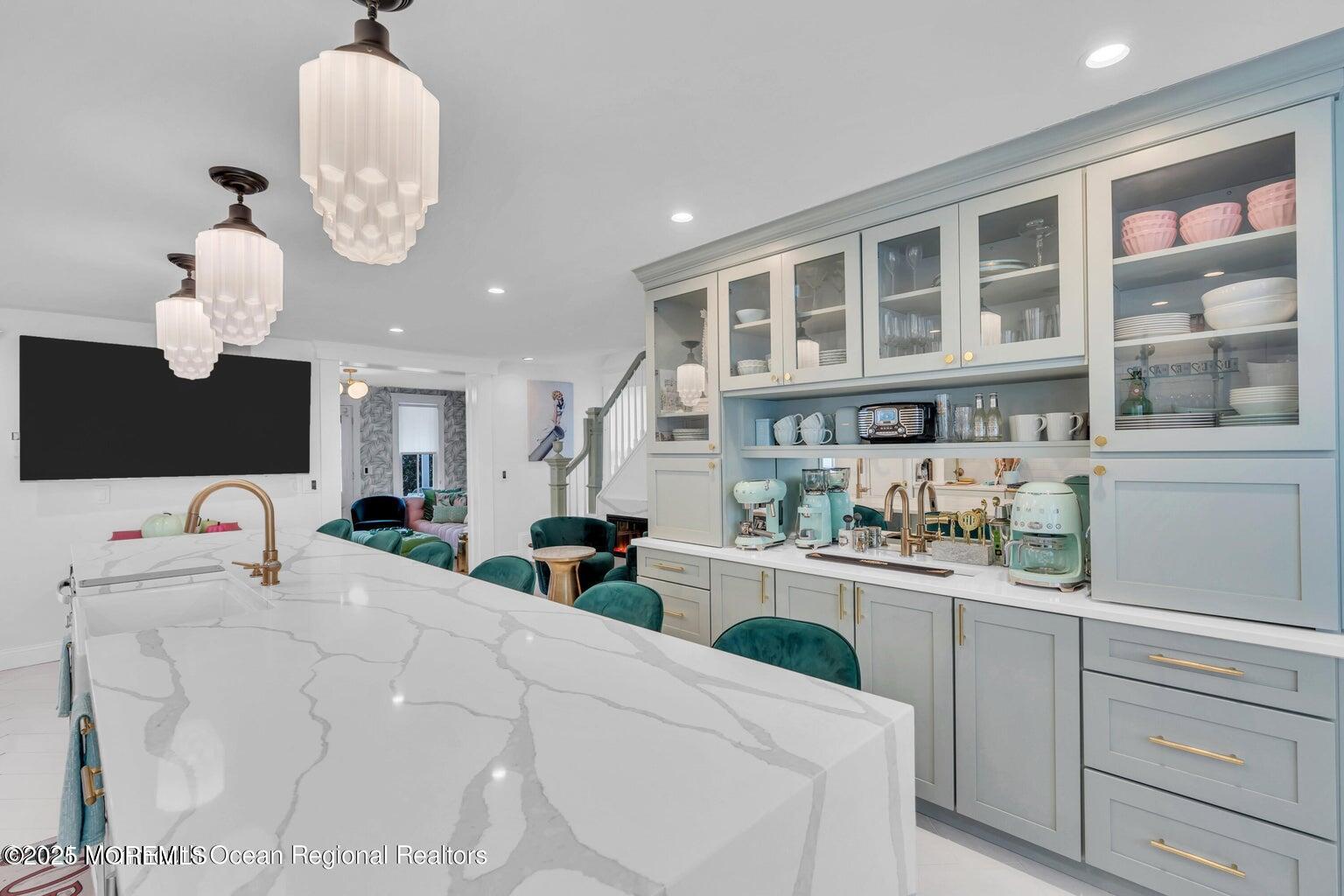 69 Webb Avenue Ocean Grove, NJ 07756 - Photo 18 of 70 a large white kitchen with a sink and dishwasher a stove top oven with wooden floor