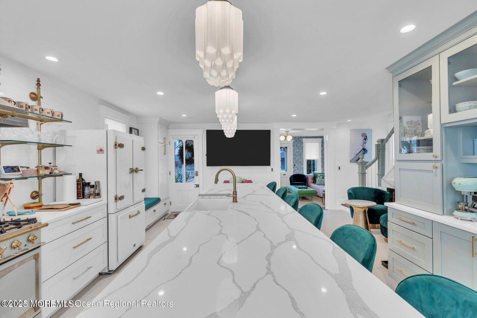 69 Webb Avenue Ocean Grove, NJ 07756 - Photo 20 of 70 a large white kitchen with stainless steel appliances kitchen island granite countertop a sink and cabinets