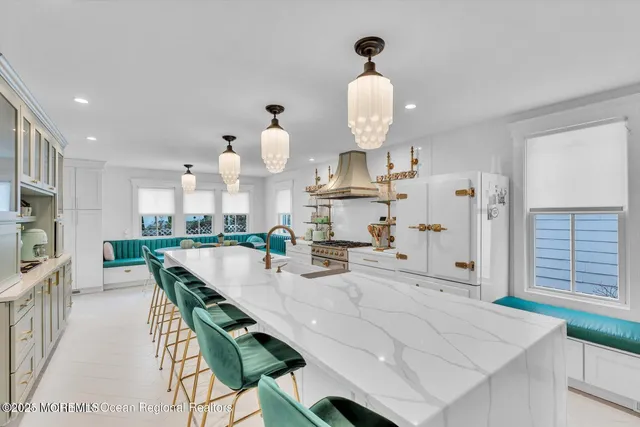 a kitchen with kitchen island stainless steel appliances a table and chairs