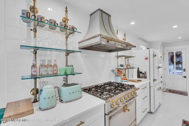 a view of a dining room with furniture a kitchen and wooden floor