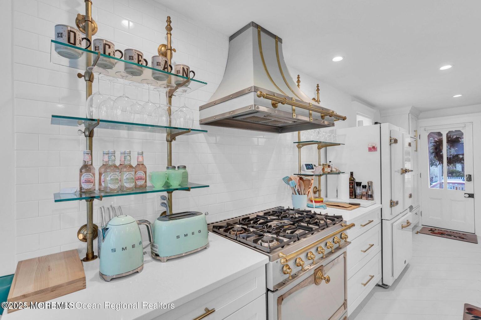 69 Webb Avenue Ocean Grove, NJ 07756 - Photo 24 of 70 a kitchen with a stove a chandelier and a table