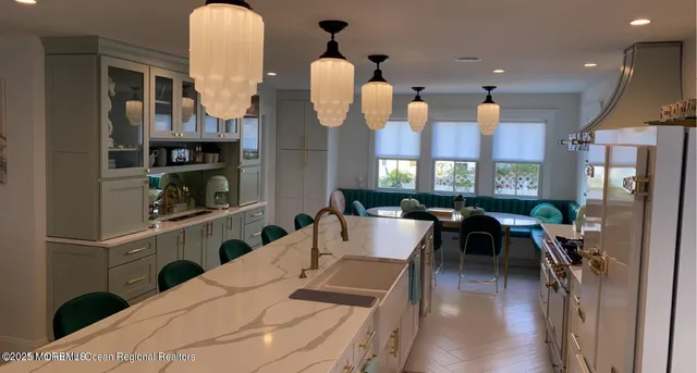 a view of a kitchen with fridge and workspace
