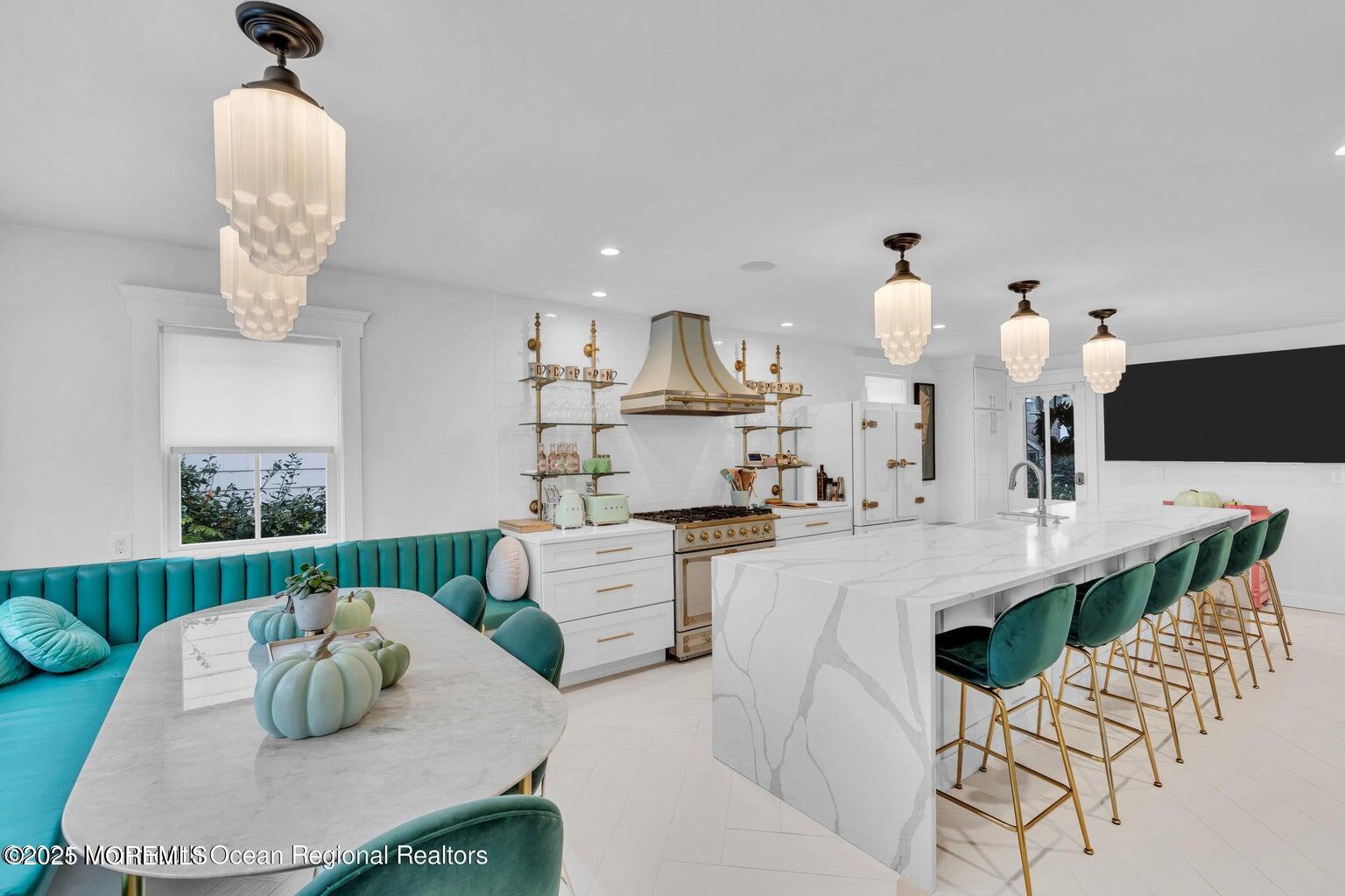 69 Webb Avenue Ocean Grove, NJ 07756 - Photo 32 of 70 a kitchen with kitchen island stainless steel appliances a table and chairs
