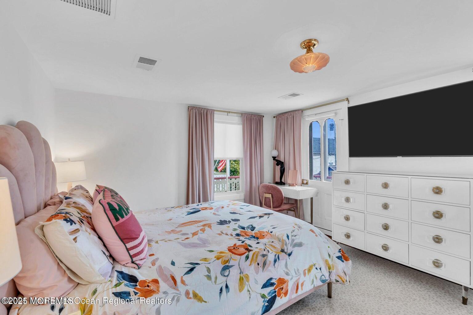 69 Webb Avenue Ocean Grove, NJ 07756 - Photo 41 of 70 a bedroom with a bed and a flat screen tv in it