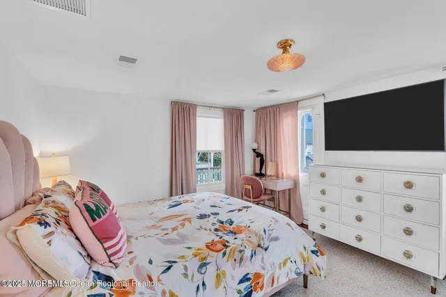 a bedroom with a bed and a lamp on table