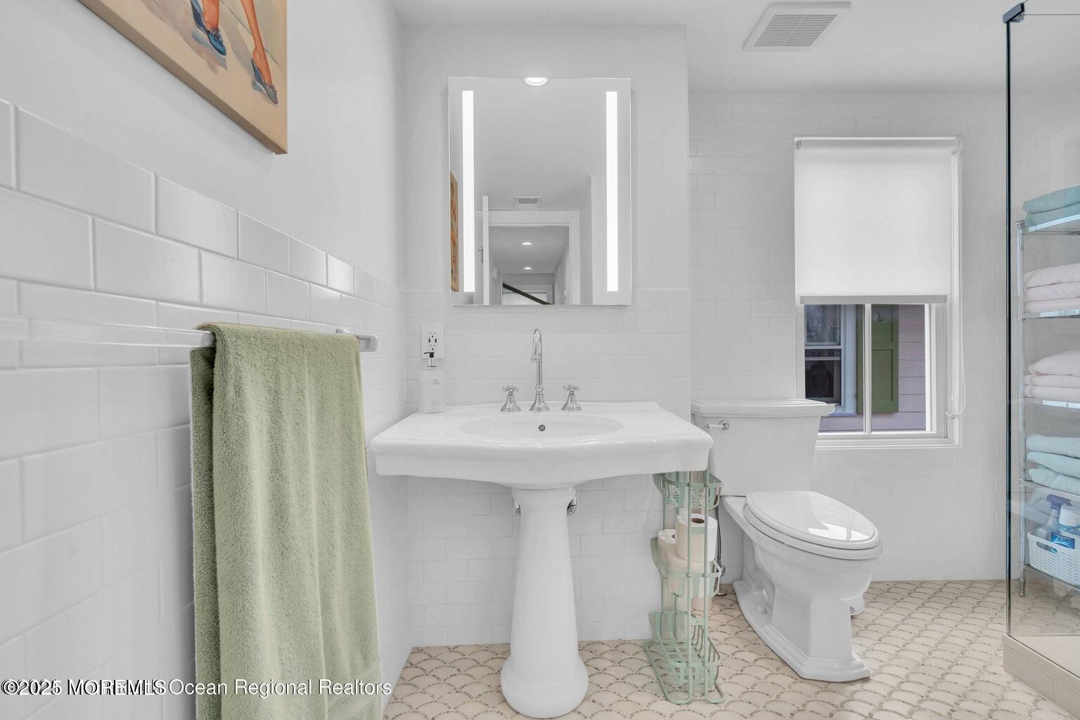 69 Webb Avenue Ocean Grove, NJ 07756 - Photo 57 of 70 a bathroom with a toilet sink and mirror