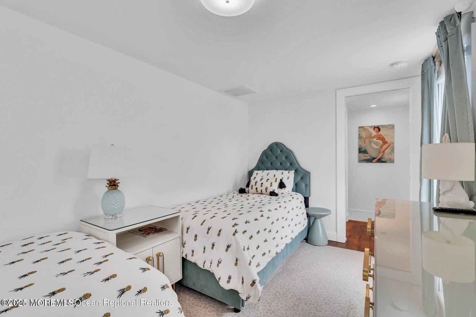 69 Webb Avenue Ocean Grove, NJ 07756 - Photo 58 of 70 a bedroom with a bed and a lamp on table