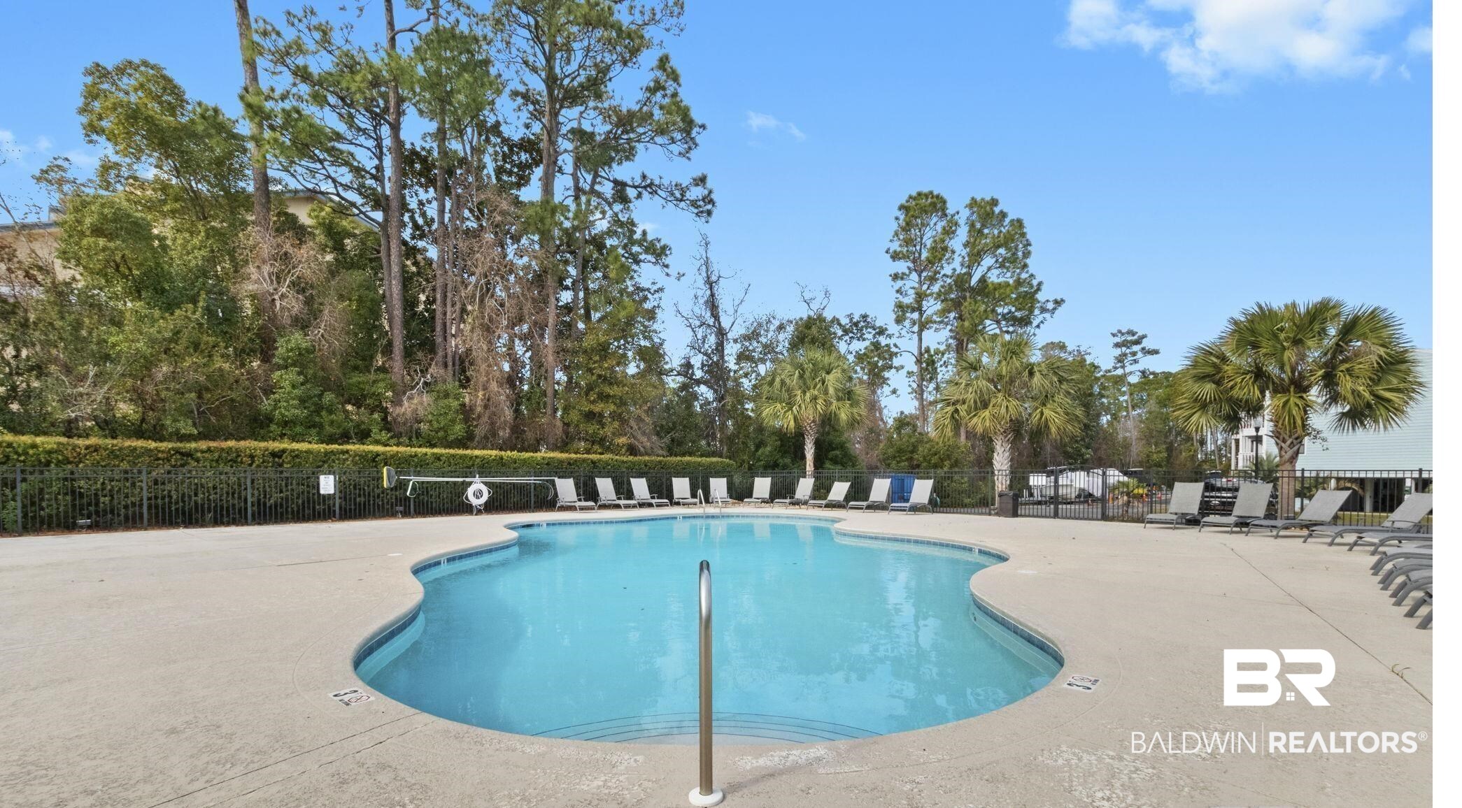 25861 Canal Road, Unit 77 Orange Beach, AL 36561 - Photo 41 of 48 Community pool featuring a patio