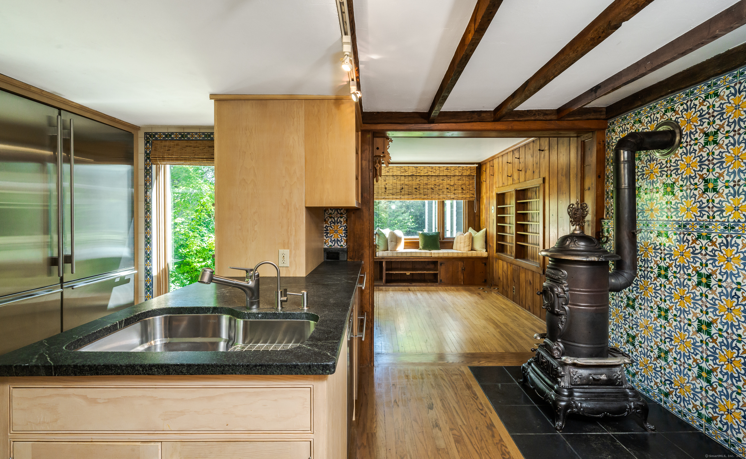 130 Sharon Mountain Road Sharon, CT 06069 - Photo 12 of 38 a kitchen with a sink and wooden cabinets
