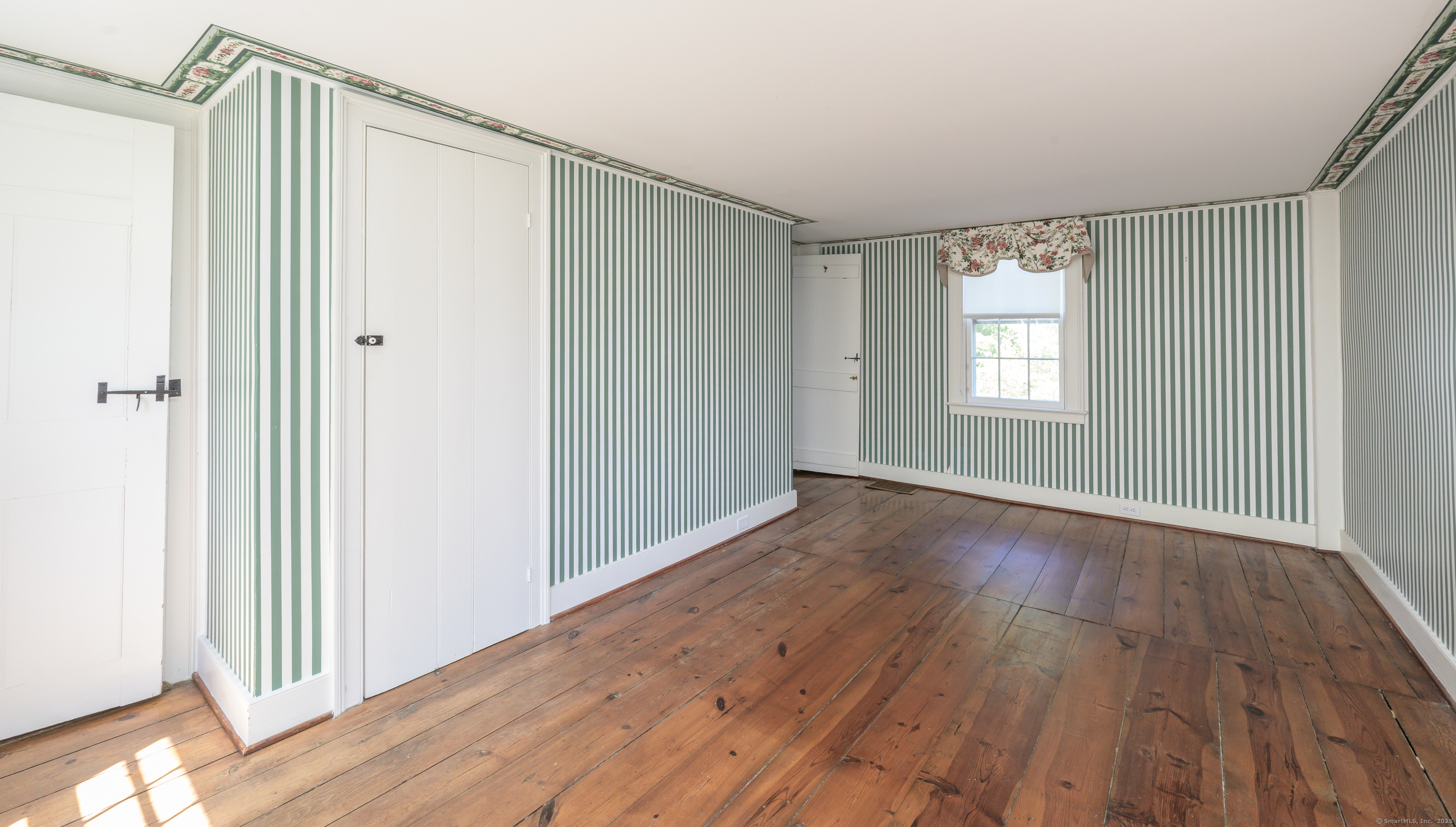 130 Sharon Mountain Road Sharon, CT 06069 - Photo 23 of 38 a view of an empty room with wooden floor and a window