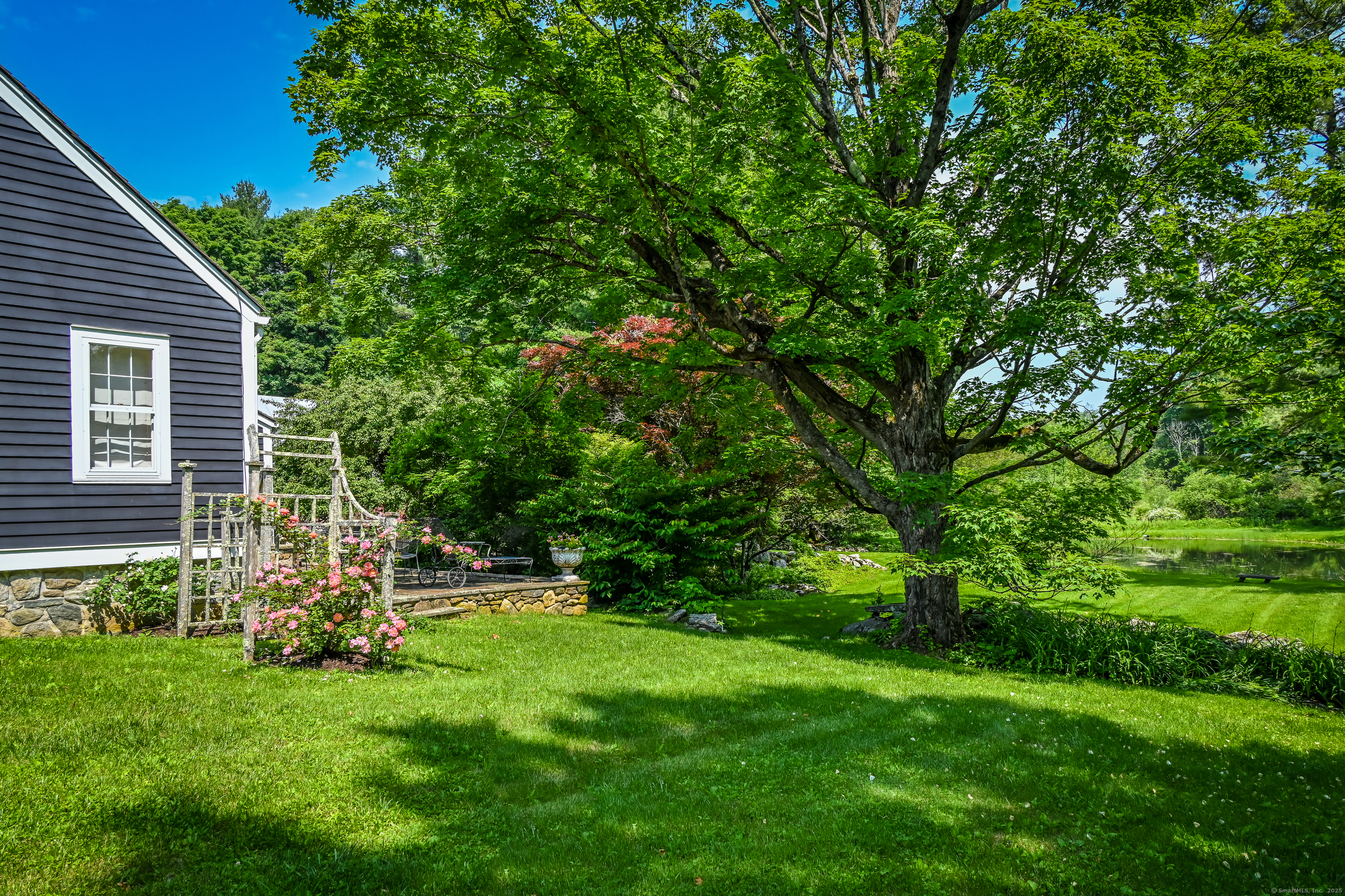 130 Sharon Mountain Road Sharon, CT 06069 - Photo 28 of 38 a view of a backyard with table and chairs and large tree
