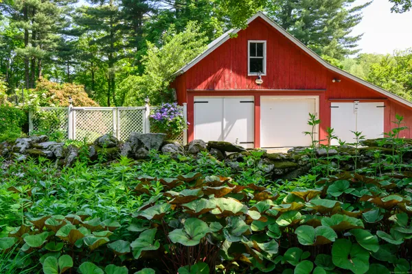 a front view of a house with a small yard and plants