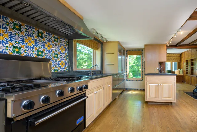 a kitchen with a stove a sink and a refrigerator
