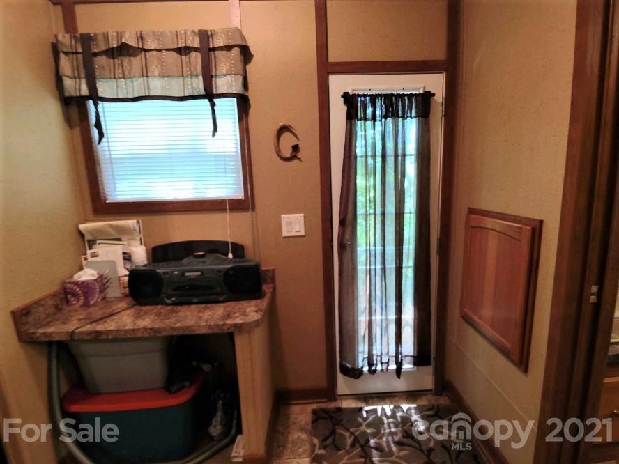 83 Choke Berry Ridge, Unit 1 Sylva, NC 28779 - Photo 10 of 13 a room with a fireplace and a wooden floor