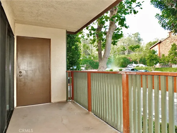 a view of a balcony with wooden floor