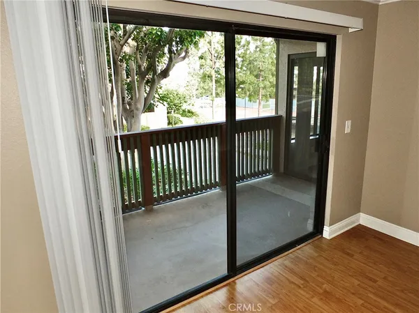 a view of a room with wooden floor and windows