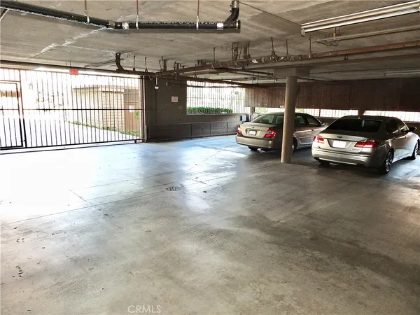 a view of parking garage with cars parked