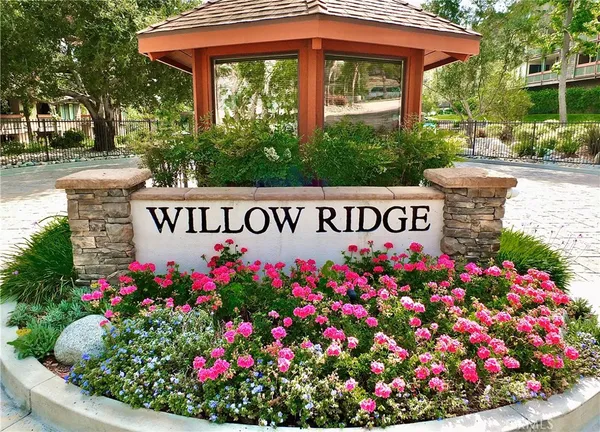 a sign that is in front of flowers
