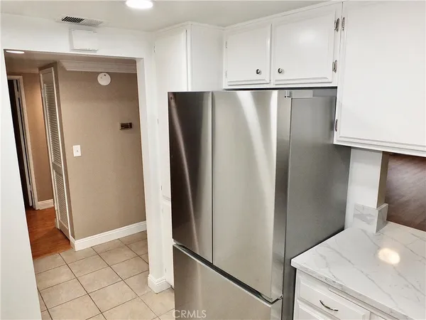 a kitchen with metallic refrigerator freezer and dishwasher