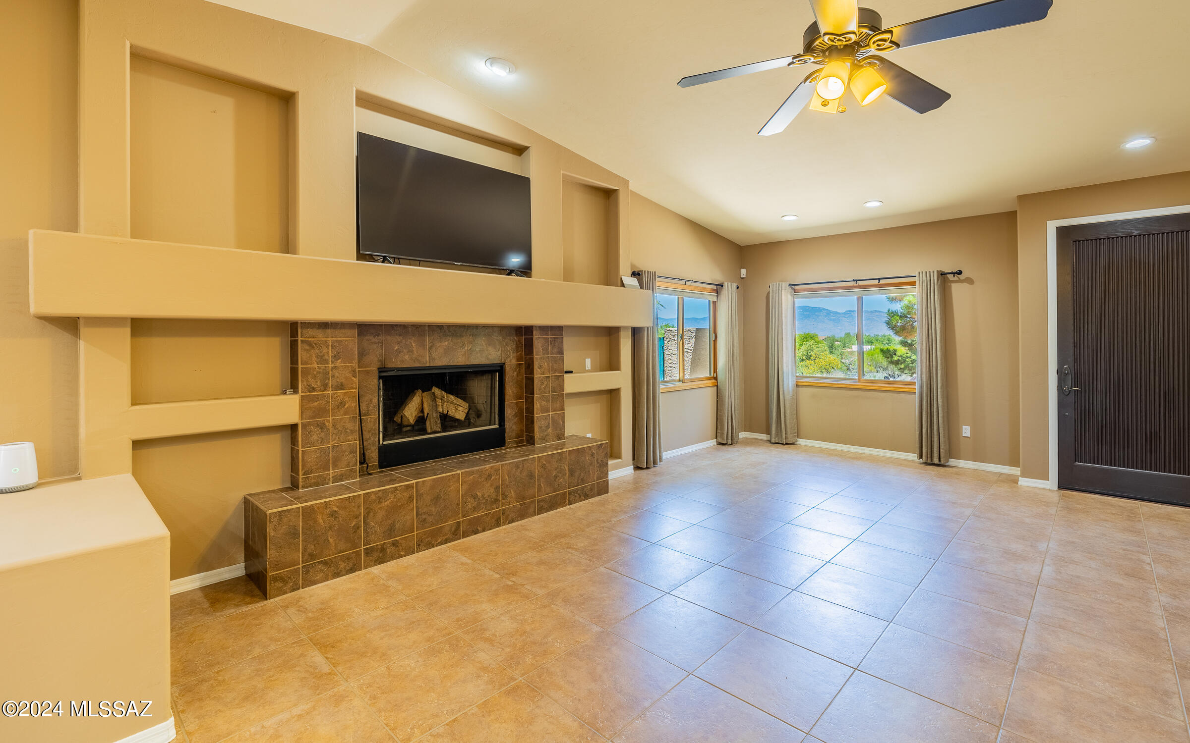 341 Sharon Road Vail, AZ 85641 - Photo 4 of 50 a view of an empty room with a fireplace and a window