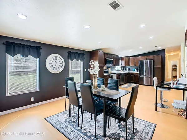 a view of a dining room with furniture and wooden floor
