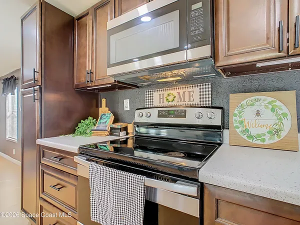 a kitchen with stainless steel appliances a stove a cabinets and a counter top space