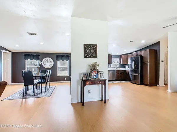 a living room with furniture and kitchen view